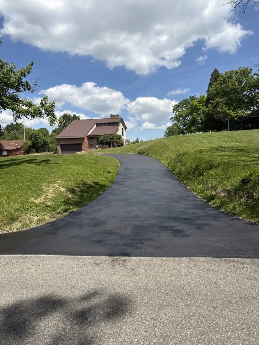 A freshly hand-sealed deep black driveway
